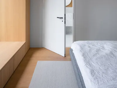 Modern minimalist bedroom featuring minimalist design elements like wood, marble, and metal.