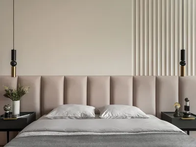 Modern bedroom with fabric headboard and pillows, featuring contemporary design elements.