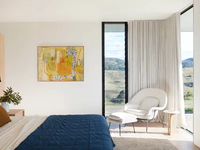 Modern minimalist bedroom featuring wood, fabric, and glass materials and design elements.