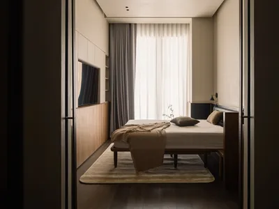 Minimalist bedroom featuring neutral-toned bed, brown floor, and large windows with sheer curtains.