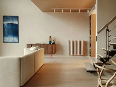 A modern residential interior featuring minimalist design, wood flooring, and contemporary furniture.