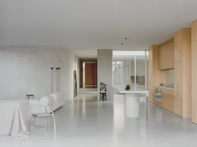 Minimalist residential kitchen with concrete flooring, minimalist furniture, and sleek, modern design.