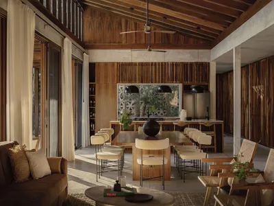 A minimalist residential kitchen with wooden elements and a modern design.