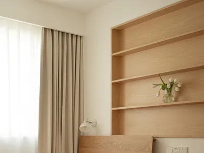 Bedroom with a minimalist design featuring neutral tones and a single furniture piece.