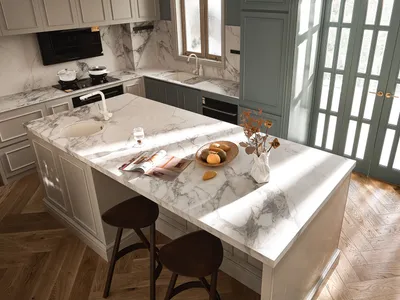 Modern, minimalist kitchen with a large marble countertop.