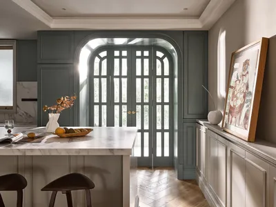 Modern kitchen features marble white cabinets and wooden flooring