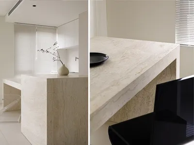 White marble kitchen countertop with a single black dinner plate.