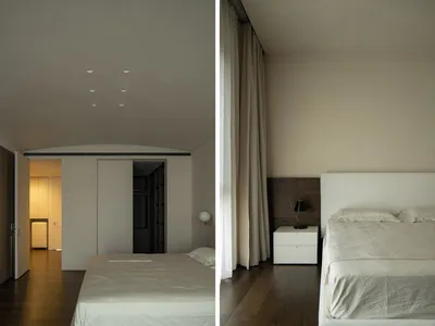 Modern minimalist bedroom with white beds and curtains, wooden flooring.