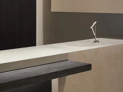 Modern minimalist bathroom featuring a sleek marble counter with a simple faucet.