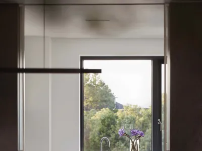 Modern kitchen with marble countertop and window view of nature