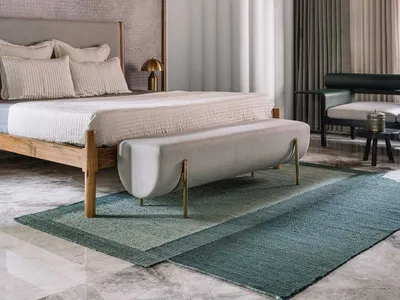 Modern minimalist bedroom featuring a wooden floor, upholstered furniture, and a large window with curtains.