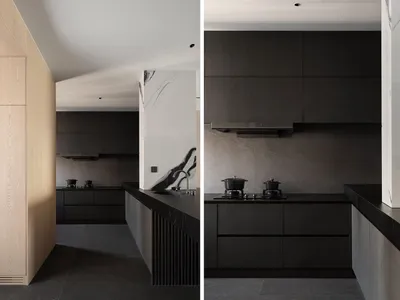 Modern kitchen featuring black marble countertops and wooden cabinets.