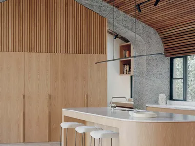 A modern kitchen with a marble countertop and wooden cabinets.