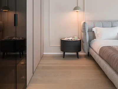 A modern minimalist bedroom featuring neutral-toned materials and a minimalist design.