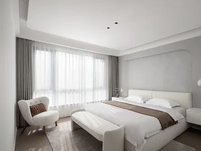 A modern bedroom with a bed dressed in fabric and white curtains.