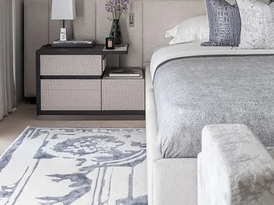 A modern minimalist bedroom featuring a bed with a fabric headboard and wooden nightstand.