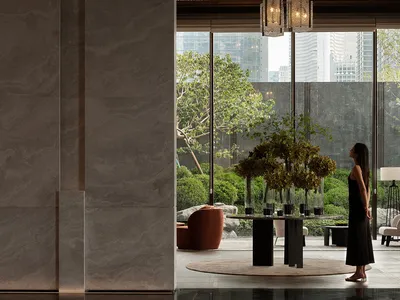 Modern hotel lobby featuring a glass chandelier hanging from the ceiling.