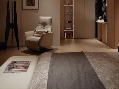 A minimalist bedroom featuring a wooden floor and furniture.