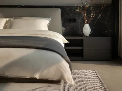 Minimalist bedroom with a bed, nightstand, and abstract art.