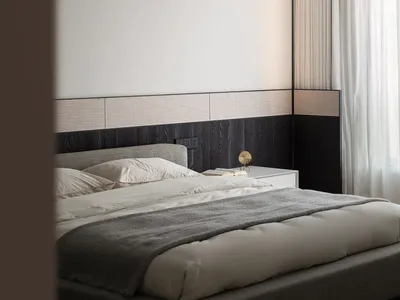 A modern minimalist bedroom with a fabric bed, white walls, and curtains.