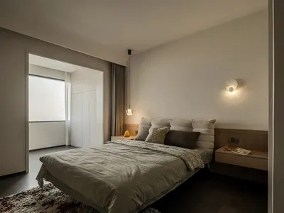 Minimalist bedroom featuring a bed with simple, clean lines, and a minimalistic color palette.
