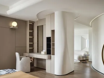 A modern minimalist bedroom with neutral tones.