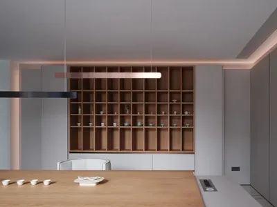 A modern, minimalist kitchen with wood finishes and clean lines.