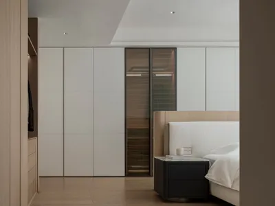 Minimalist bedroom with a wooden bed and glass walls.