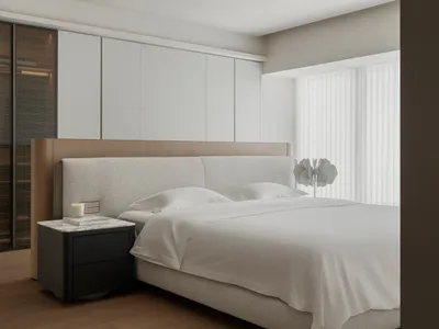 A modern minimalist bedroom featuring a white upholstered bed with a wooden headboard and a minimalistic decorative lamp on a