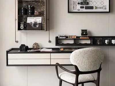 A home office space featuring a black and metallic steel floating desk with drawers, a white and black textured chair, and a