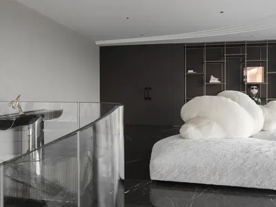 A minimalist bedroom featuring marble flooring and metallic accents