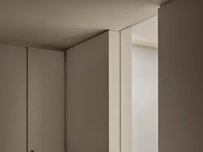 A minimalist bedroom featuring wood elements.