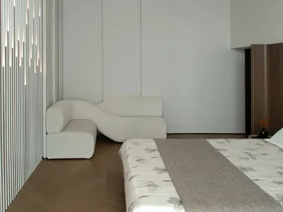 Neutral-toned minimalist bedroom with sleek lines and modern furniture.