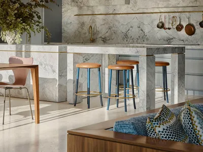 Modern kitchen with marble countertops and stools