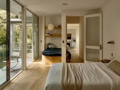 A serene minimalist bedroom with neutral tones and natural light.