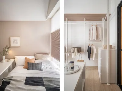 A minimalist bedroom featuring a walk-in wardrobe with a white shelf and hanging clothes, complemented by a white bed with ne