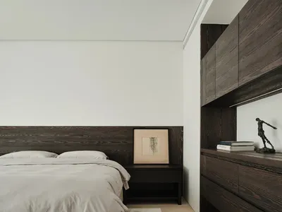 Minimalist bedroom with concrete and wood elements
