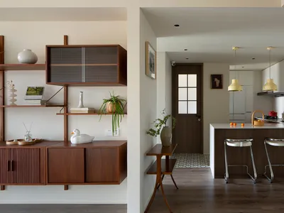 A modern kitchen with minimalist design and wooden features.