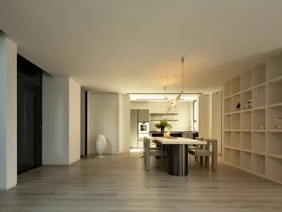Modern living, dining, and kitchen room interior with minimalist decor and open space layout.
