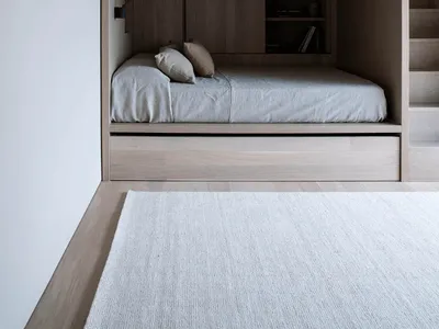 Modern minimalist bunk beds with grey bedding.