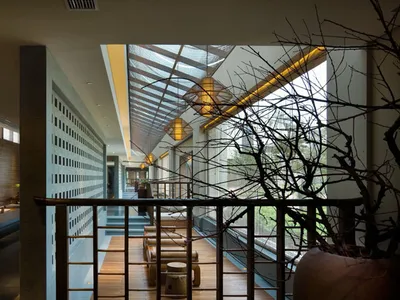 A modern restaurant bar with glass walls and sleek interior design.