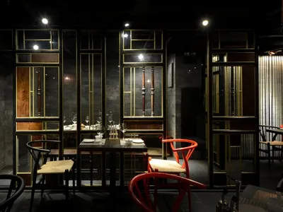 Modern restaurant interior with wooden seating and metal accents