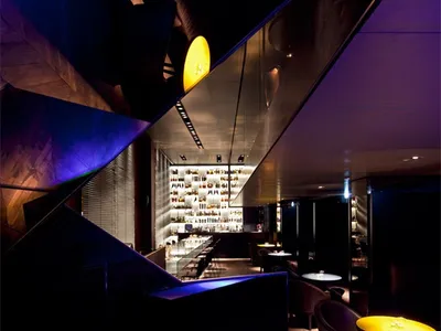 A modern restaurant interior with metallic accents and a sleek design.