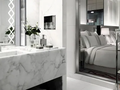 Minimalist bedroom featuring marble surfaces and luxurious bedding.