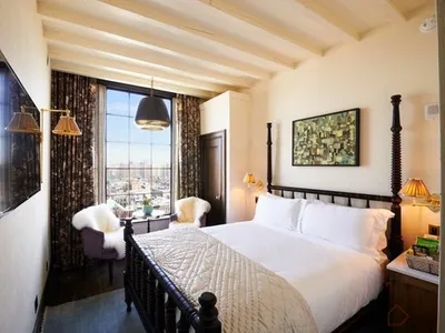 A stylish bedroom featuring modern anthropological design elements with wood and plaster