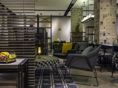 Modern interior design of a hotel reception area with metal, wood, and fabric materials.