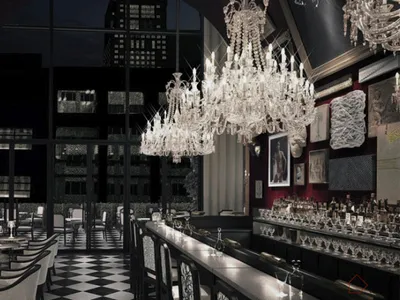 A luxurious restaurant bar with glass chandeliers and contemporary design elements.