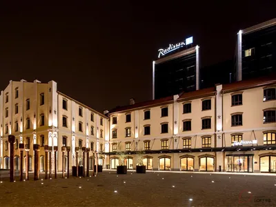 Night view of hotel exterior with brick, metal, and glass