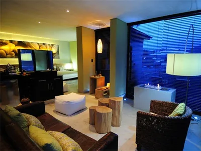 Modern minimalist living room featuring concrete blocks and natural fiber furniture, providing relaxation and ambiance.