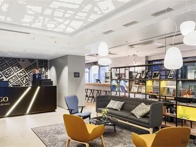 Modern hotel lounge with concrete floor and glass ceiling